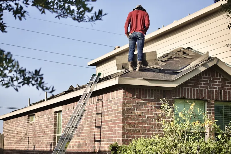 Professional roofer working on a residential roof in Ramona